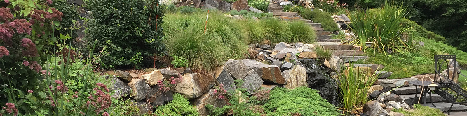 Stone stairway leading through landscaped yard